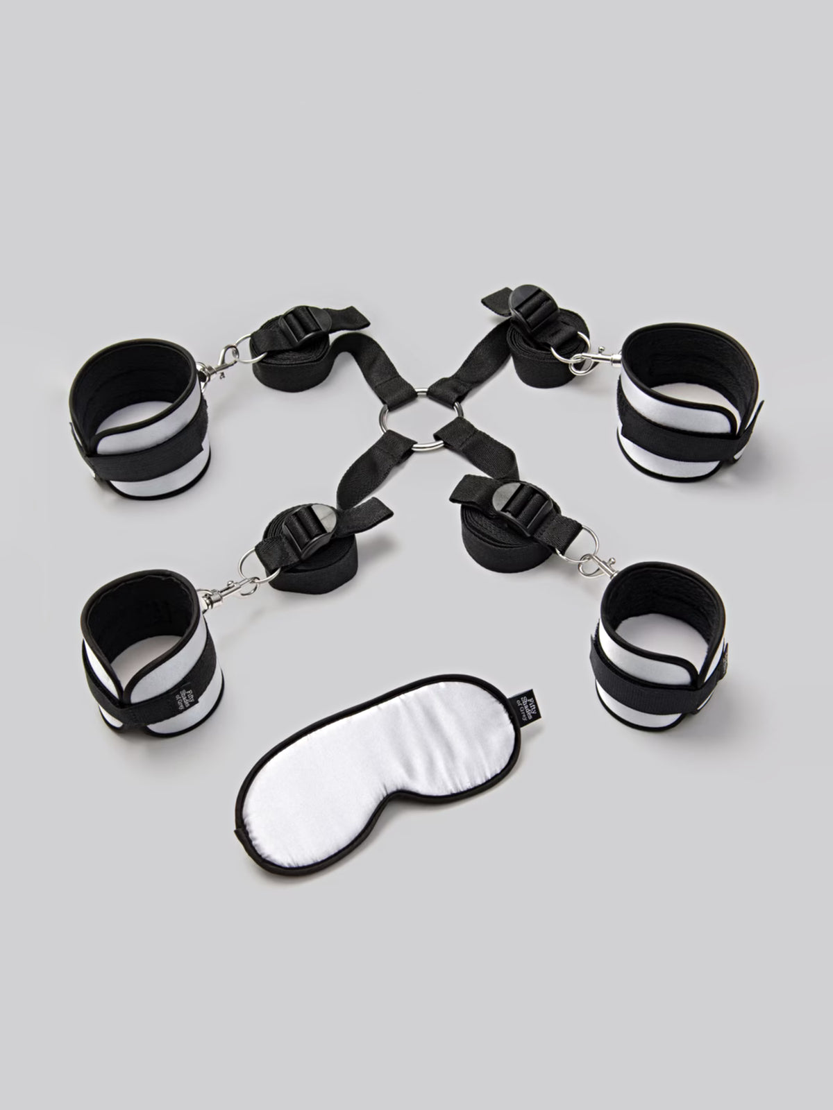 Fifty Shades of Grey Hard Limits 4-piece restraint kit featuring soft satin cuffs, adjustable straps, and a sensory blindfold.