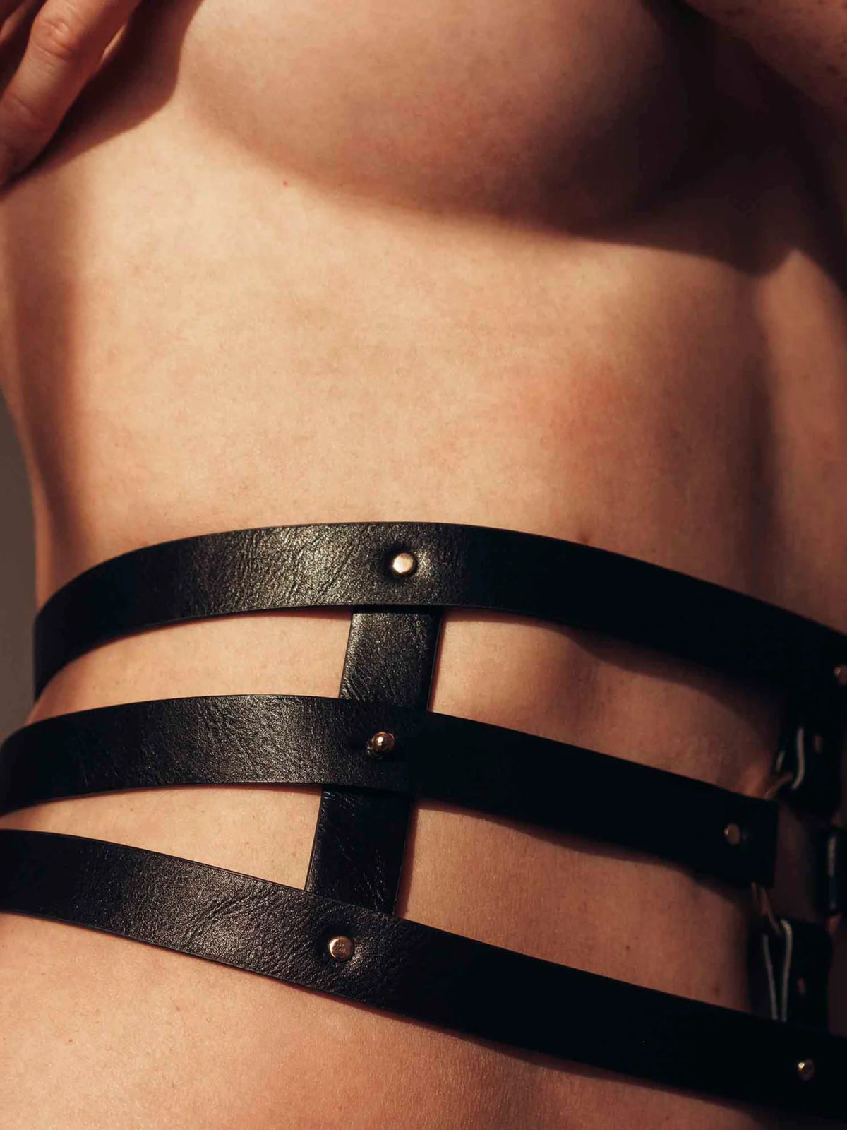 Model wearing Bijoux Indiscrets MAZE Wide Belt and Restraints, featuring adjustable black waist straps and refined hardware.