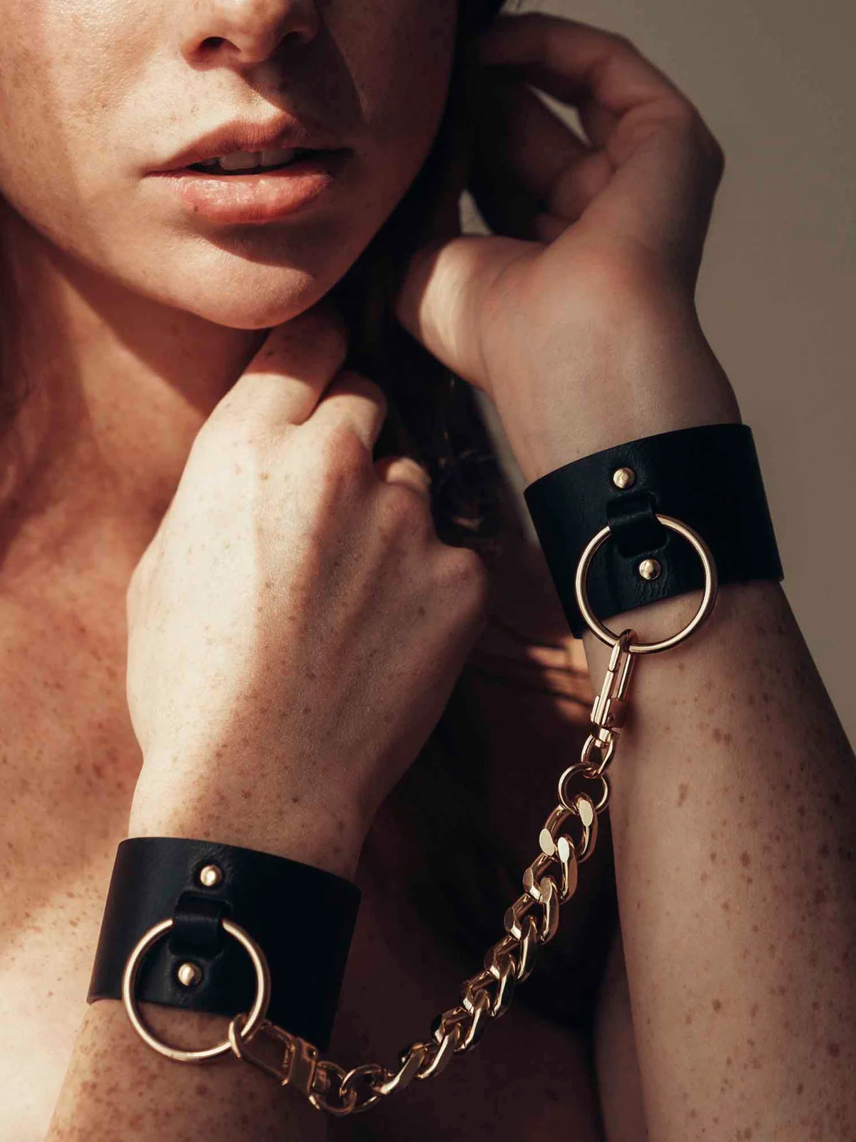 Bijoux Indiscrets MAZE Wide Cuffs featuring adjustable black straps and elegant hardware, designed for refined intimate play.