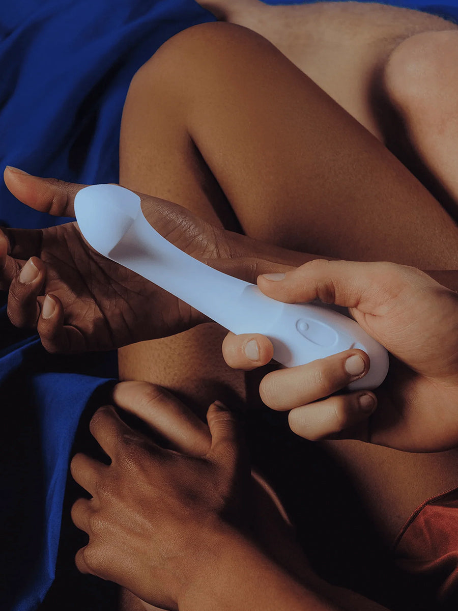 Dame Arc ergonomic internal G-spot vibrator with a squishy bulb and curved handle.