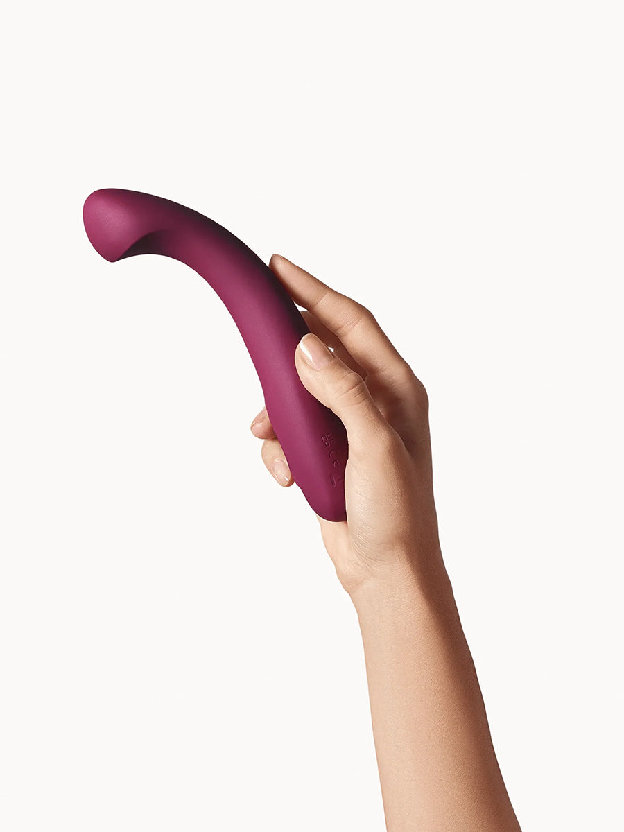 Dame Arc ergonomic internal G-spot vibrator with a squishy bulb and curved handle.