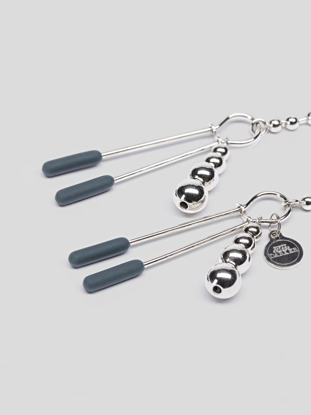 Fifty Shades Darker At My Mercy tweezer-style nipple clamps featuring weighted beaded chains and silicone-covered tips.